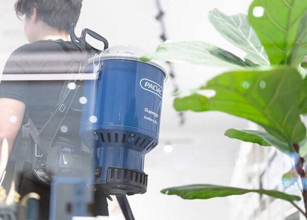 pacvac Superpro battery vacuum with plant in the foreground