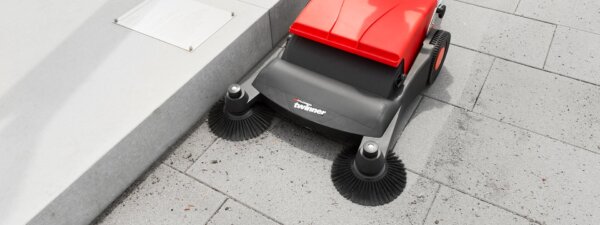 Twinner 800 manual sweeper sweeping outdoor concrete surface