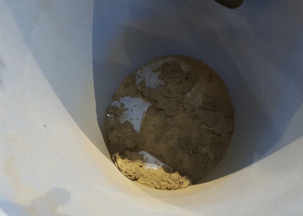 Vacuum cleaner cannister filled with dust after vacuuming escalators